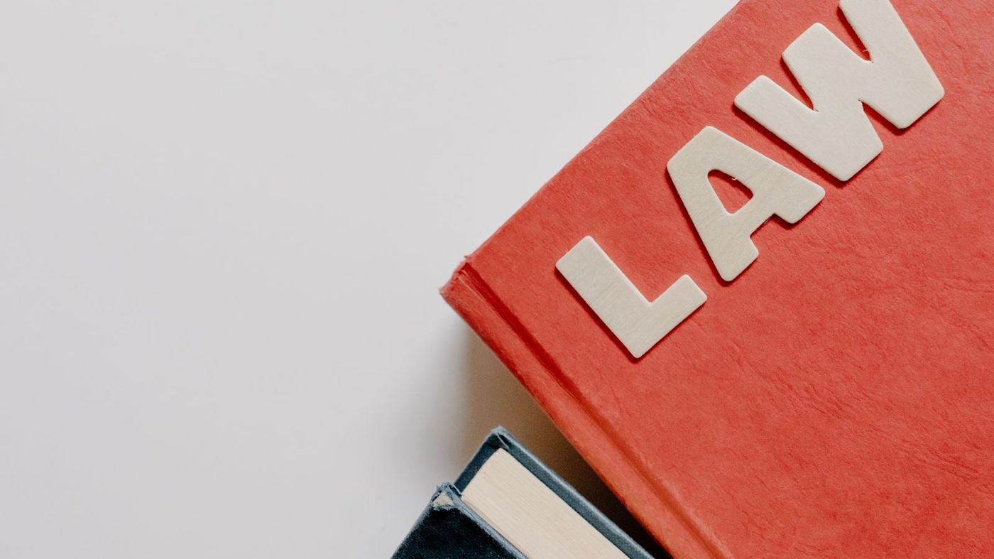 Red law book on a white surface