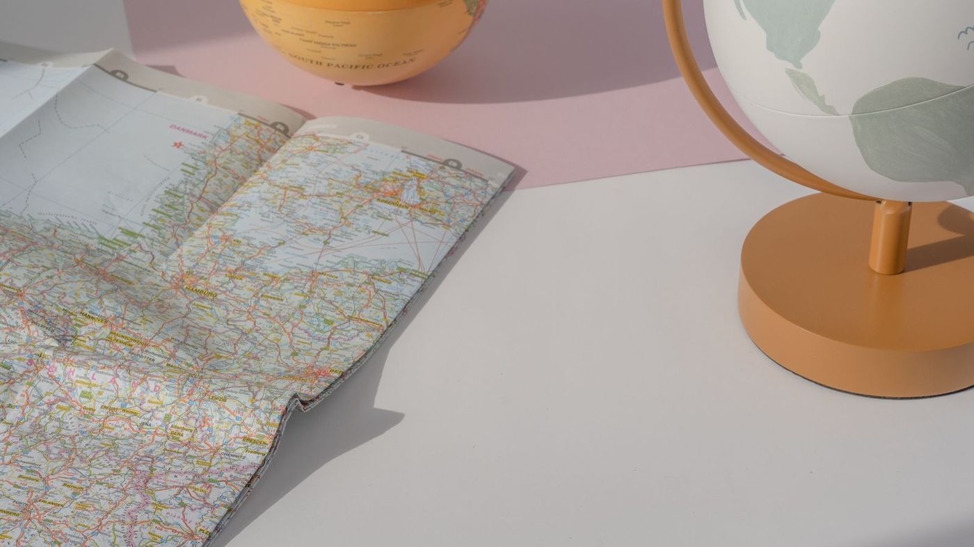 Desk globe and road map on a table