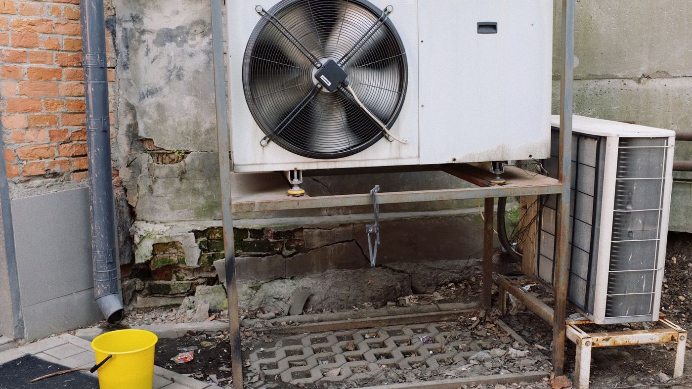 Outdoor air conditioner unit installed on a building wall