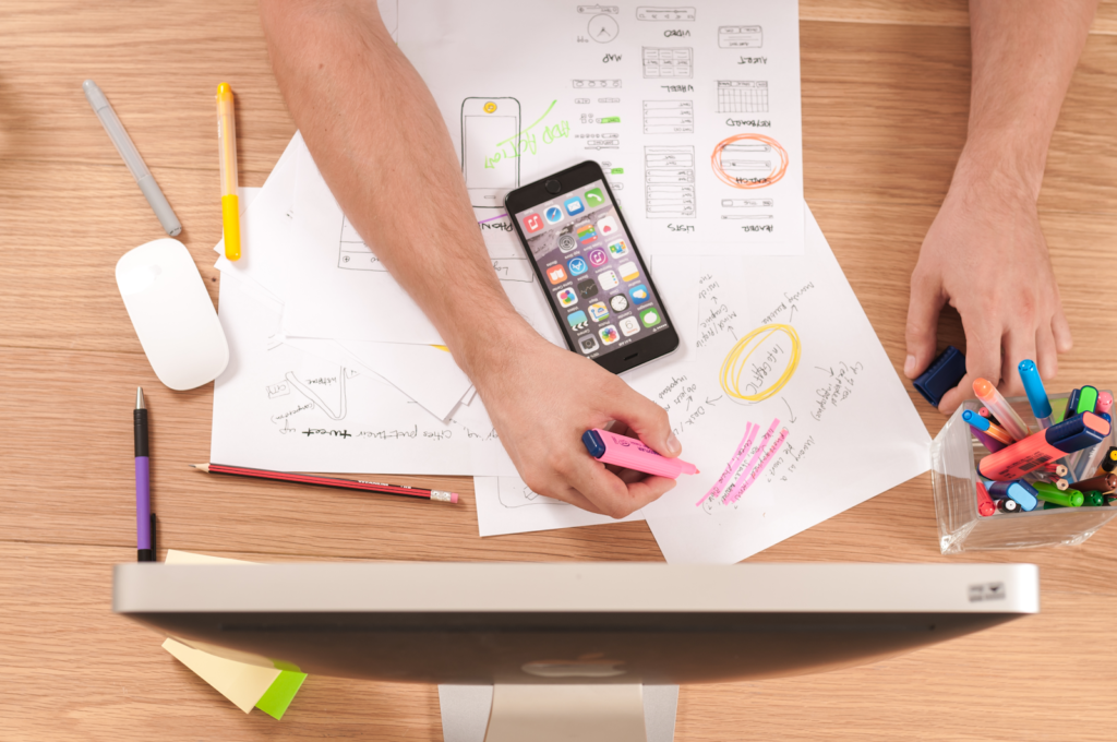 Laptop on a desk showing a website layout for landing page design